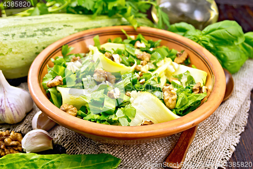 Image of Salad with squash and sorrel in plate on dark board