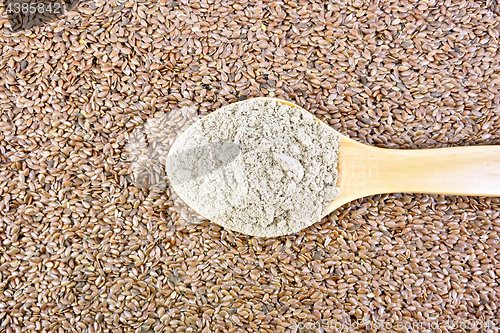 Image of Flour linen in wooden spoon on seeds