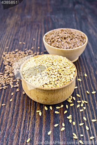 Image of Flaxen white and brown seed in bowl on board