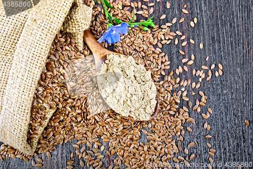 Image of Flour flax in spoon with flower on board top