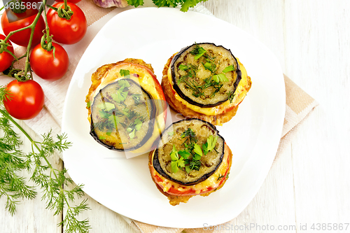 Image of Appetizer of aubergines and cheese in plate on board top