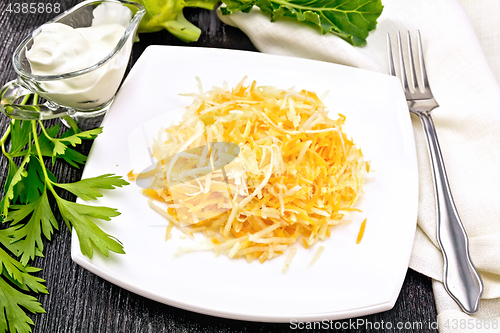 Image of Salad of carrot and kohlrabi in white plate on board