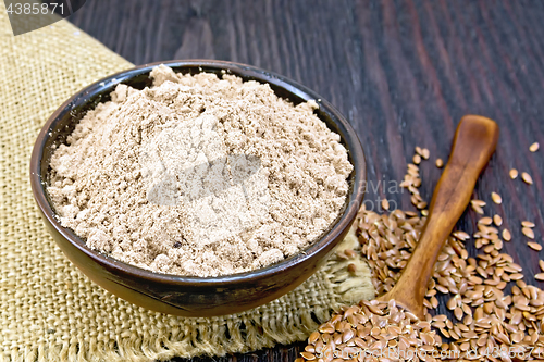 Image of Flour linen in bowl with seeds in spoon on sacking