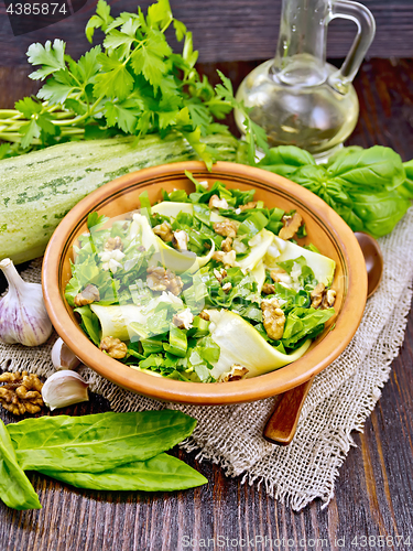 Image of Salad with squash and sorrel on dark board