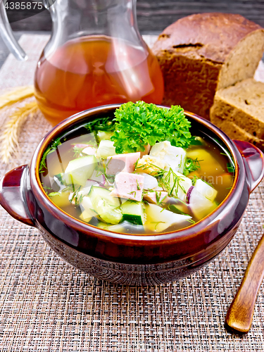 Image of Okroshka in clay bowl on wicker napkin