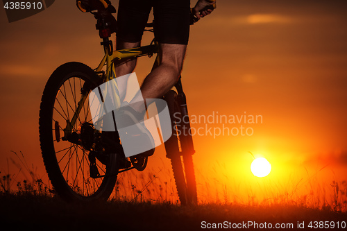 Image of Silhouette of a bike on sky background