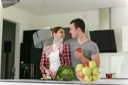 Image of Young handsome couple in the kitchen