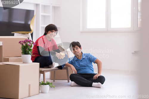 Image of boys with cardboard boxes around them