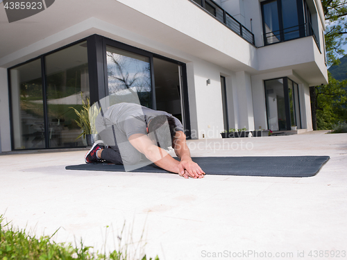Image of man doing morning yoga exercises