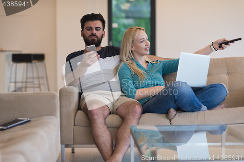 Image of young happy couple relaxes in the living room