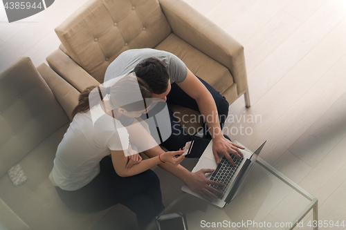 Image of happy young couple buying online