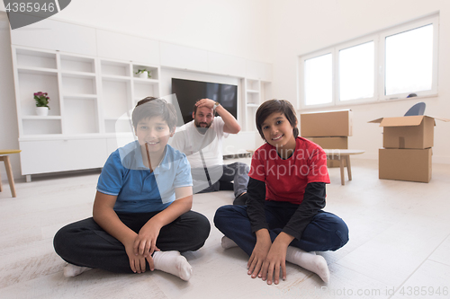 Image of portrait of happy young boys with their dad