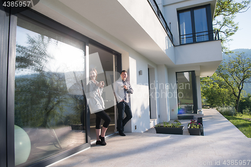 Image of couple enjoying on the door of their luxury home villa