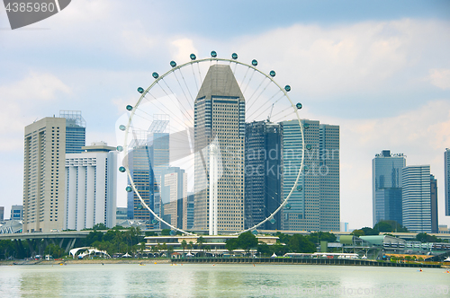 Image of Singapore Ferries Wheel and skyscrapers