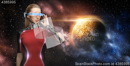 Image of female robot in virtual reality glasses over space