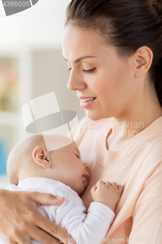 Image of close up of mother holding sleeping baby