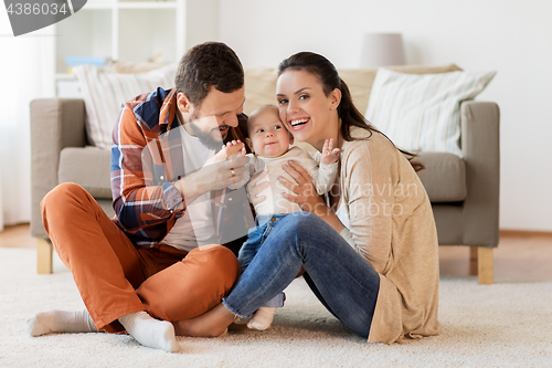 Image of happy family with baby having fun at home