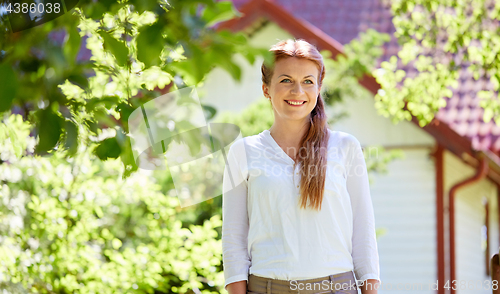 Image of happy smiling woman at summer garden