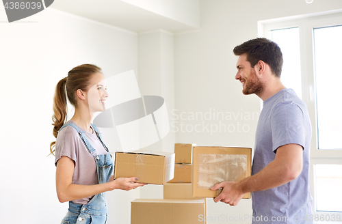 Image of happy couple with boxes moving to new home