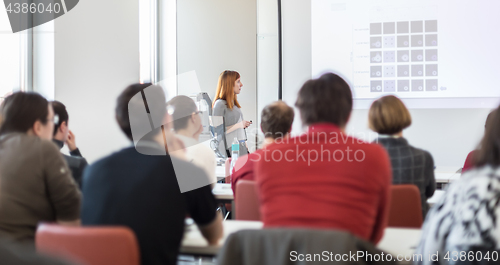 Image of Woman giving presentation in lecture hall at university.