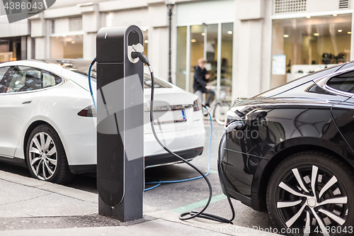 Image of Charging modern electric car on the street as future of automotive industry.