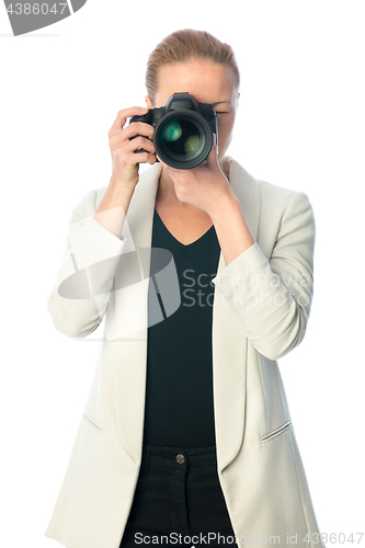 Image of Beautiful young photographer with camera in professional studio