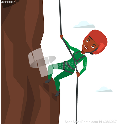 Image of Woman climbing in mountains with rope.