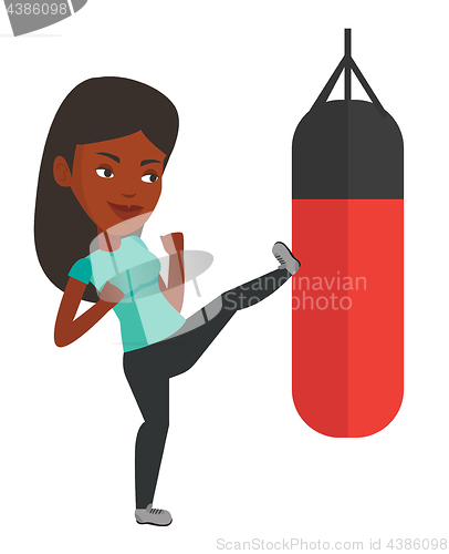 Image of Woman exercising with punching bag.