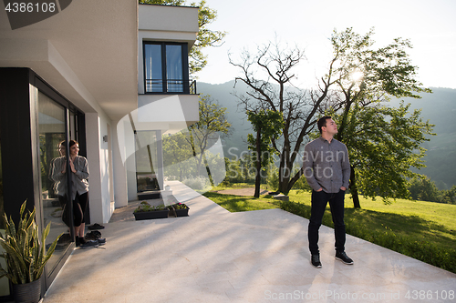 Image of man in front of his luxury home villa