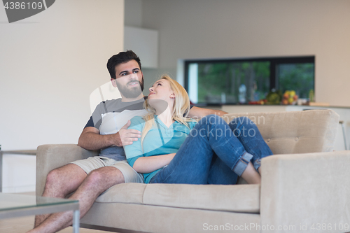 Image of young happy couple relaxes in the living room