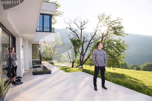 Image of man in front of his luxury home villa