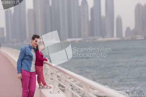 Image of mother and cute little girl on the promenade