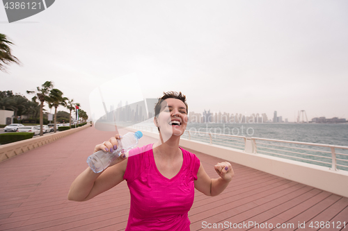 Image of young woman celebrating a successful training run