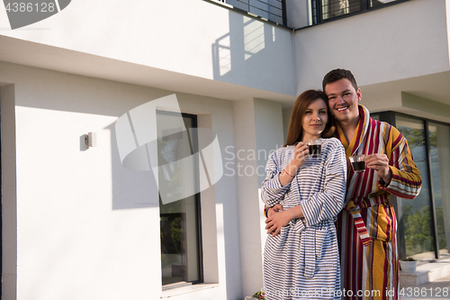 Image of Young beautiful couple in bathrobes