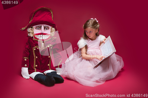 Image of The beauty ballerina sitting with nutcracker