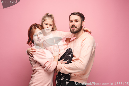 Image of Happy young family with one little daughter posing together