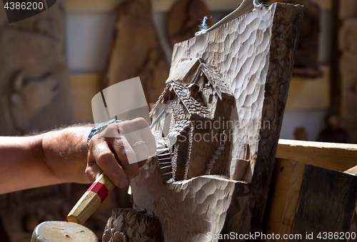 Image of Sculptor hands working wood