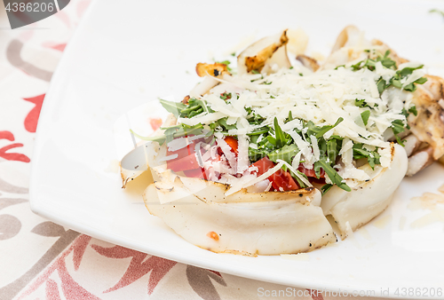 Image of Cuttlefish with tomato, salad and Parmigiano cheese