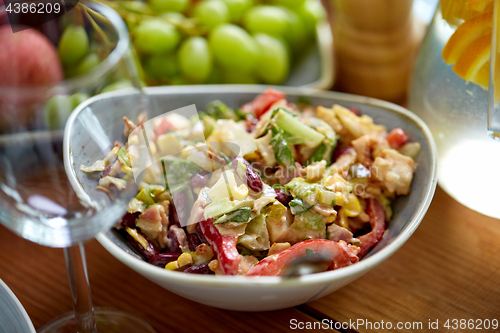 Image of smoked chicken salad in bowl on wooden table