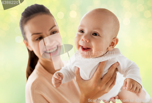 Image of happy mother with little baby boy over green