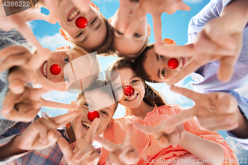 Image of children showing peace hand sign at red nose day