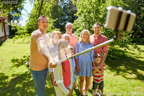 Image of happy family taking selfie in summer garden