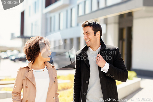 Image of office workers or couple talking on city street