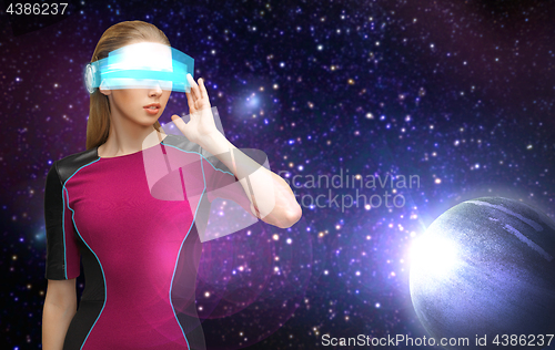 Image of woman in virtual reality glasses over space