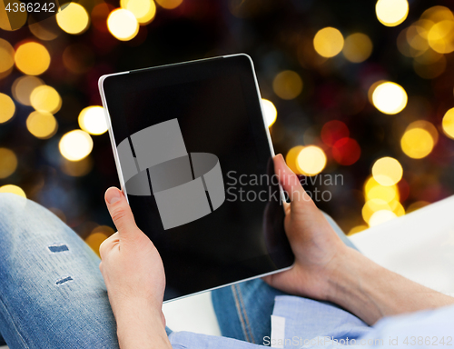 Image of close up of male hands holding tablet pc