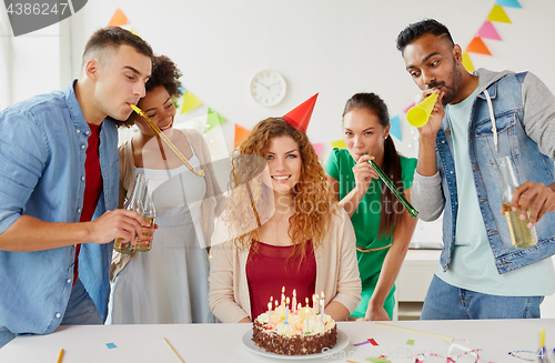 Image of happy coworkers with cake at office birthday party