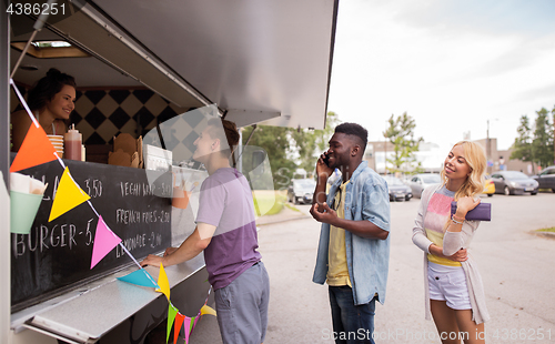 Image of happy customers queue at food truck