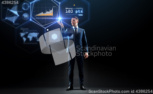 Image of businessman working with charts on virtual screen