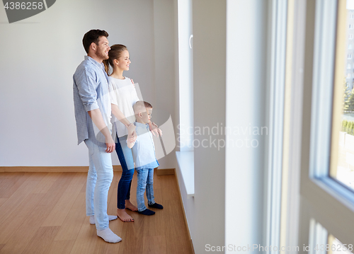 Image of happy family with child at new home or apartment