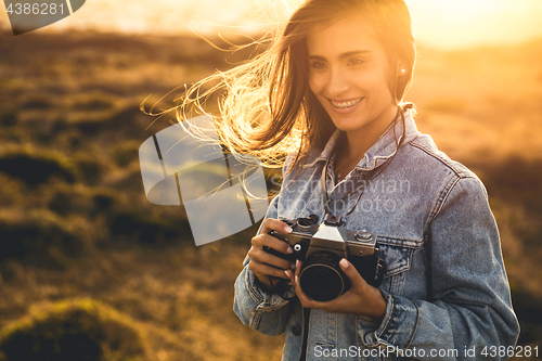 Image of Woman Taking Picture Outdoors